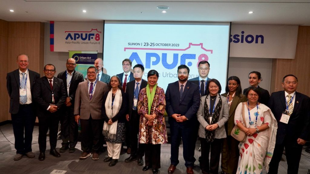 A group photo featuring Heinrich Gudenus, the Urban-Act Project Director, and Bernadia Irawati Tjandradewi, the Secretary-General of UCLG ASPAC, along with the panelists, keynote speaker, and moderator