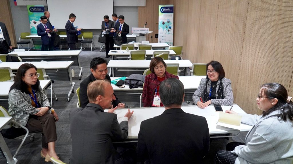 A small group discussion between Heinrich Gudenus, the Urban-Act Project Director, and Ann Liza Bonagua, the Director of DILG in The Philippines, along with their respective teams, after the session